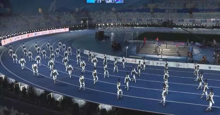Droids demonstrate precision marching at world humanoid robot games opening
