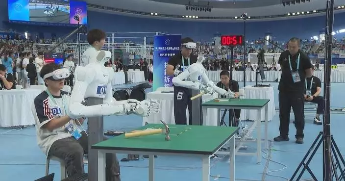 Robots compete to hammer nails with precision at humanoid robot games in Beijing