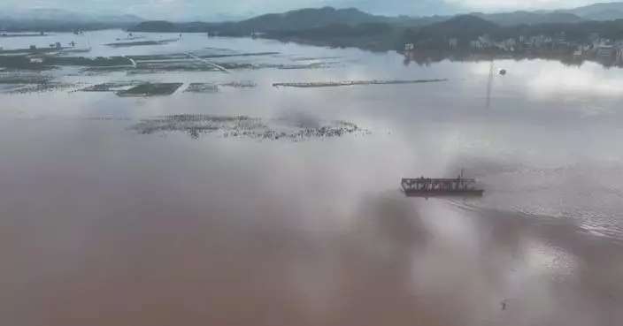 Powered pontoon bridge used to transfer locals, supplies in flooded village