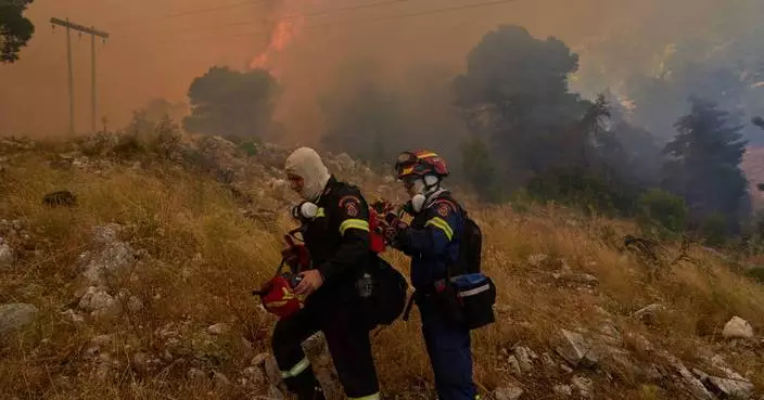 Firefighters scramble to contain fires outside Athens before winds and high temperatures return