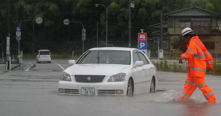 Heavy rain and flooding in north-central Japan strands people and vehicles