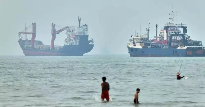 Cargo ship reports being struck in Strait of Hormuz as US, Iran claims about talks diverge