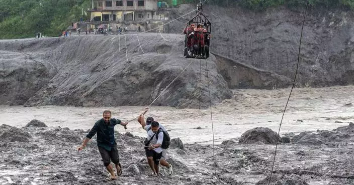 Trading food for medicine and crossing the river by zip line are part of life in Nepal flood zone