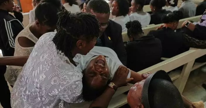 Mourners file into a church in Haiti where gangs killed dozens of people in latest rampage