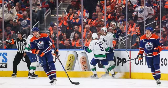 Paul Cotter scores in OT as the Canucks beat the Oilers 6-5 in the opener