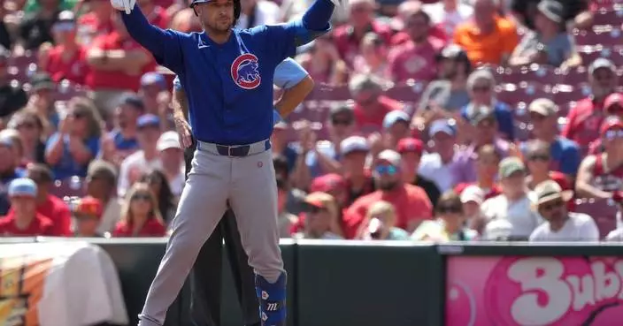 Cubs 3B Alex Bregman exits after being hit in the face by a foul ball while in the on-deck circle