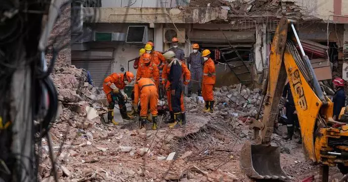 Rescuers search for people trapped in a New Delhi building collapse as death toll rises to 6