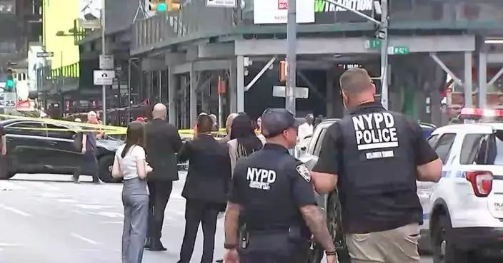 A woman brandishing two knives is shot by police in Times Square