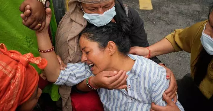 Photos show a family in Nepal bid farewell, as other flood victims are buried in unmarked graves