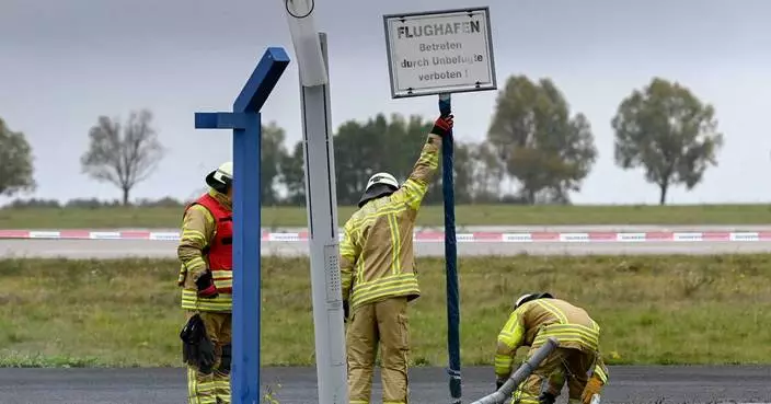German authorities investigate a hole cut into a fence at Leipzig airport