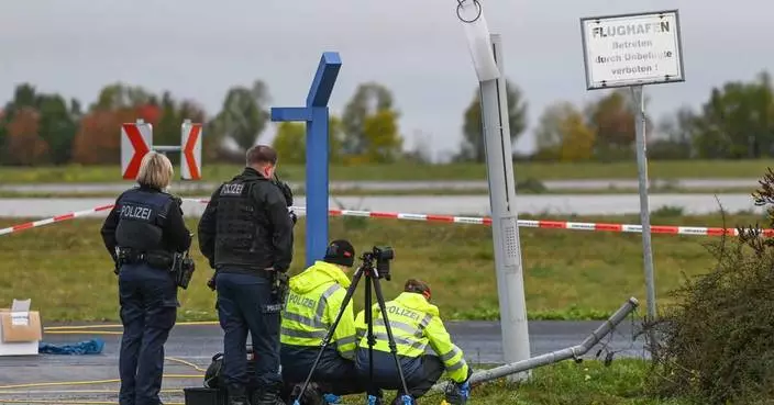 German police say 2 men turned themselves in after smashing their car into an airport fence