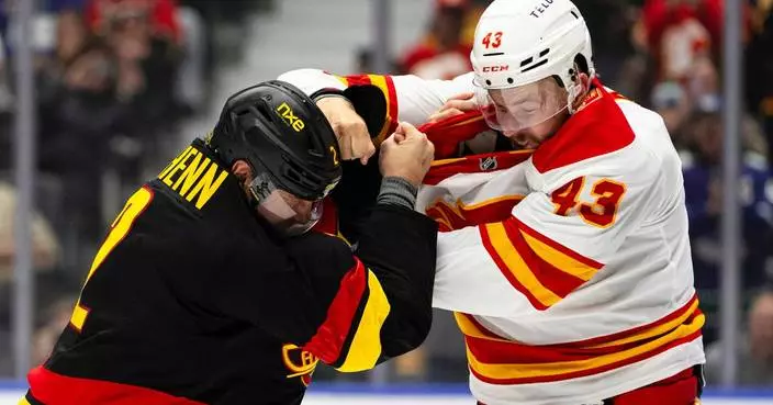 Merilainen makes 23 saves in first start for the Canucks in a 4-1 victory over the Flames