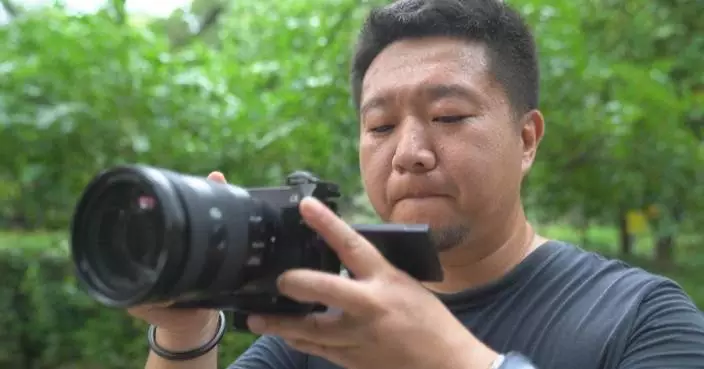 Named after National Day, camera operator witnesses China's transformation through his lens