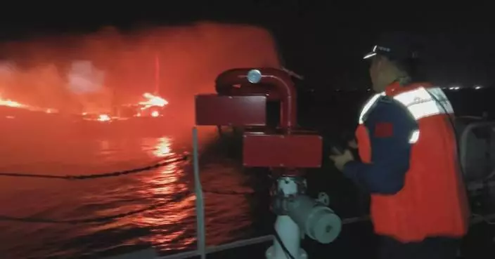 Eight rescued after fishing boat catches fire in south China