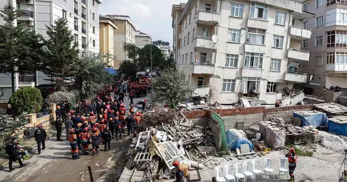 A partial building collapse in Istanbul kills 1 and traps at least 3 people