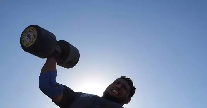 Burly men in Gaza pull trucks and flip tires in competition of strength