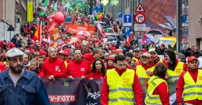 Police and masked protesters clash in Brussels as anti-austerity rally disrupts city